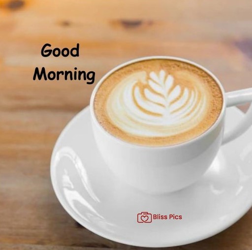 upside view of cappuccino in white cup and saucer on wooden table upside view of cappuccino in white cup and saucer on wooden table - good morning images with coffee